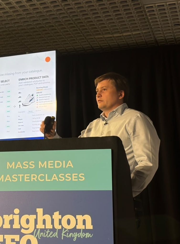 Paul Ryazanov at the BrightonSEO lectern, October 2026